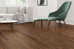 Green chairs and dining table on light brown laminate floor